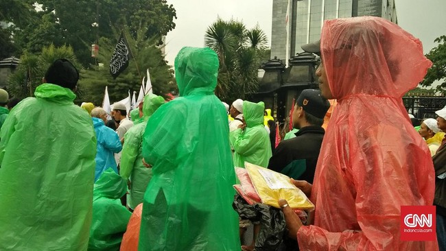 Pedagang jas hujan mendapat untung besar saat berjualan di tengah aksi massa di depan Polda Metro Jaya. Barang jualan mereka laris manis.