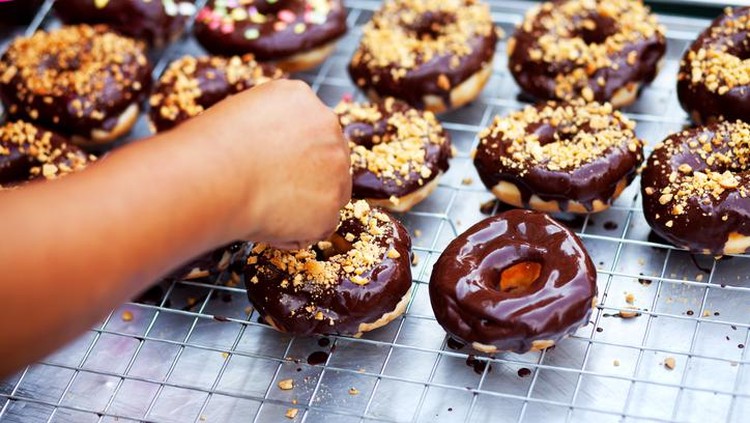 Donuts and candies on wooden table. Top view with copy space