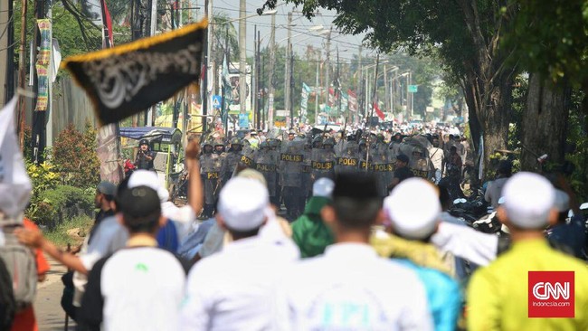 Ratusan massa berpakaian serba putih berunjuk rasa di depan Gereja Santa Clara. Mereka mengancam akan terus berdemo jika polisi tak menyegel gereja itu.
