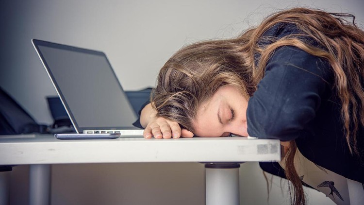 Woman sleeping at desk