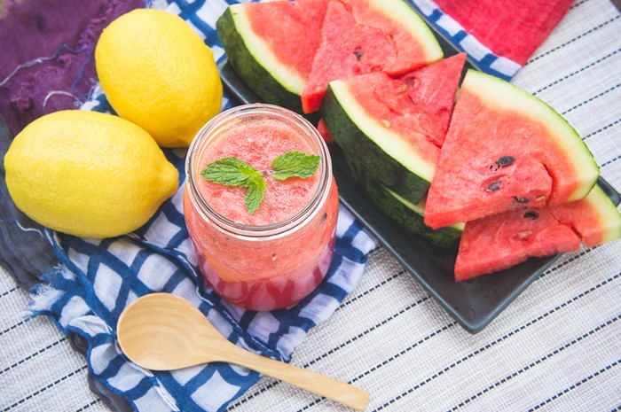 Fresh mojito with watermelon on a wooden table