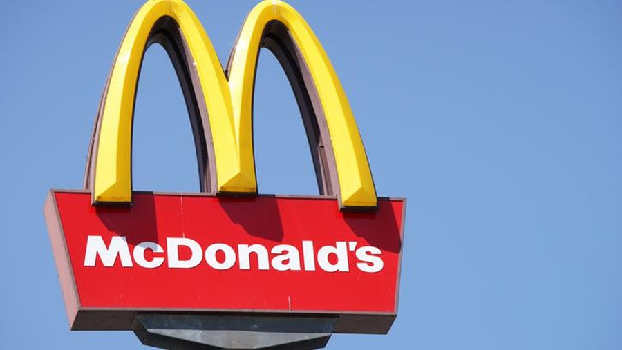 Ljubljana, Slovenia - September 3, 2011: Close-up of McDonalds outdoor sign with  typical rounded yellow M letter against cloudless blue sky. Sign is positioned on the left side of image.