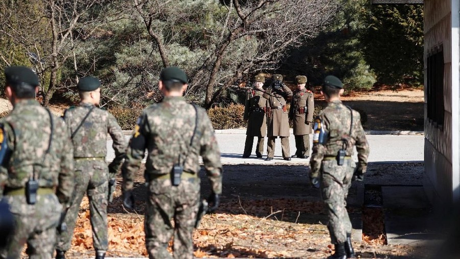 South and North Korean soldiers keep watch each other next to a spot where a North Korean has defected crossing the border on November 13, at the truce village of Panmunjom inside the demilitarized zone, South Korea, November 27, 2017.     REUTERS/Kim Hong-Ji