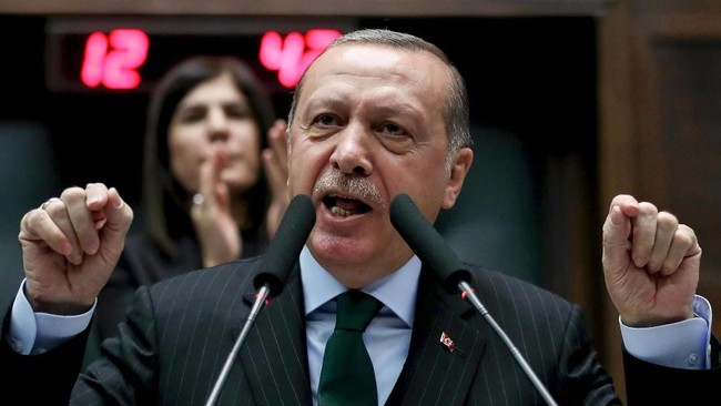 President of Turkey and Leader of the Justice and Development Party (AKP), Recep Tayyip Erdogan, gestures as he gives a speech during an AK party's group meeting at the Grand National Assembly of Turkey (TBMM) in Ankara, on December 5, 2017. / AFP PHOTO / ADEM ALTAN