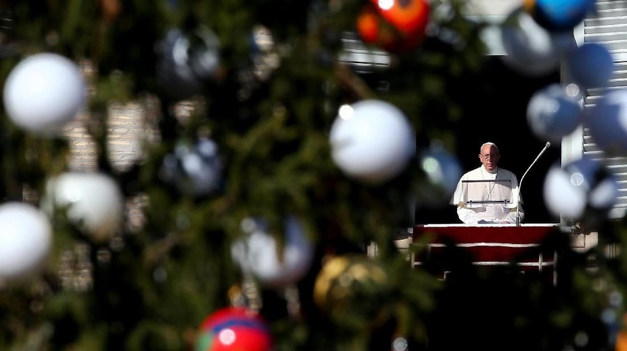 Pope Francis appears during his Angelus prayer in Saint Peter's Square at the Vatican, December 24, 2017.