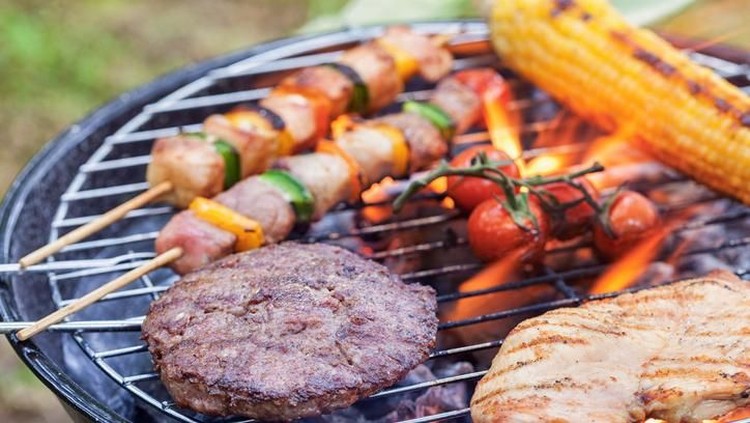 Tasty Kebabs Shishkabobs on Grill with wood skewers&comma; and a medley of food being grilled to perfection in a shallow depth of focus look&period;  Chicken&comma; pepper&comma; onions&comma; glaze and squash&period;