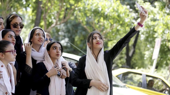 Polisi Iran dikecam netizen setelah video yang memperlihatkan pemrotes kewajiban berjilbab didorong hingga jatuh beredar viral, Jumat (23/2).