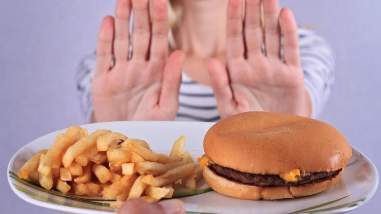 Woman refuses to eat junk food . Healthy eating and active lifestyle concept
