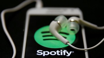 FILE PHOTO: Earphones are seen on top of a smart phone with a Spotify logo on it in this February 20, 2014 photo illustration. REUTERS/Dado Ruvic/Illustration/File Photo                        GLOBAL BUSINESS WEEK AHEAD