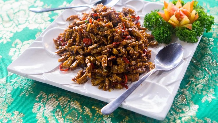 Cooked tempeh on a white plate