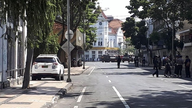 Garis polisi melintang di tiap sudut ruas jalan kawasan Mapolrestabes Surabaya. CNNIndonesia.com terjebak di jalanan lengang yang disolisasi polisi.