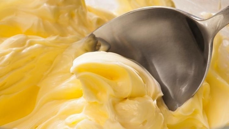 Butter cream Icing being made by mixing butter and icing sugar, part of making a cake series