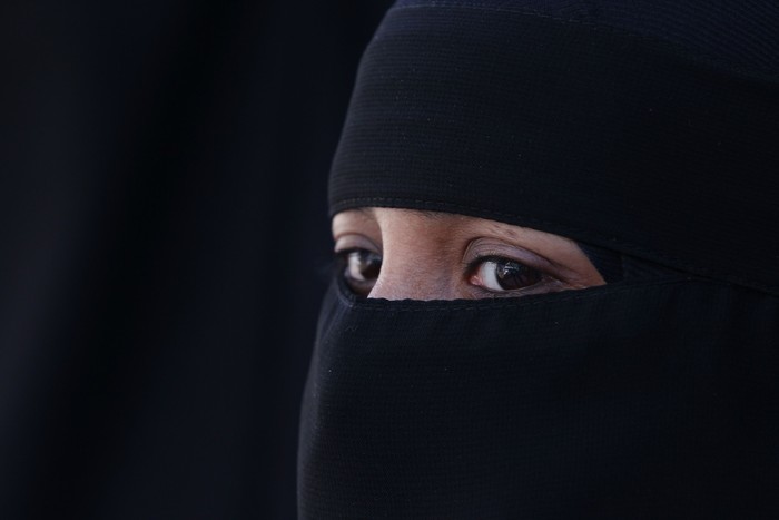LONDON, ENGLAND - APRIL 11:  A woman wears an  Islamic niqab veil stands outside the French Embassy during a demonstration on April 11, 2011 in London, England. France has become the first country in Europe to ban the wearing of the veil and in Paris two women have been detained by police under the new law.  (Photo by Peter Macdiarmid/Getty Images)