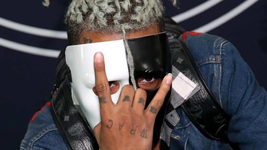 Rapper XXXTentacion MIAMI, FL - DECEMBER 15: (EDITOR'S NOTE: Best quality available) In this handout provided by the Miami Dade County Corrections, Rapper XXXTentacion, also known as Jahseh Dwayne Onfroy poses for his mugshot after being charged with seven new felonies stemming from a 2016 domestic violence case on December 15, 2017 in Miami, Florida. The new charges are for witness tampering and harassment. (Photo by Miami Dade County Corrections via Getty Images)