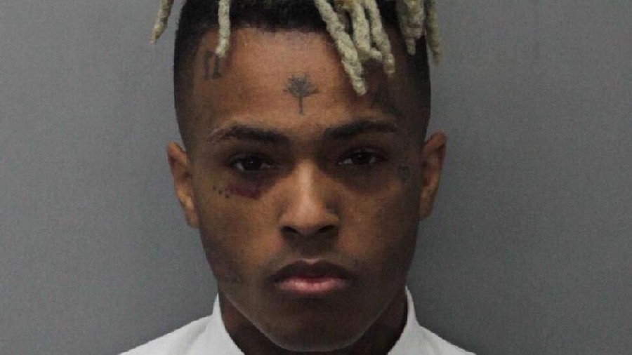 Rapper XXXTentacion MIAMI, FL - DECEMBER 15: (EDITOR'S NOTE: Best quality available) In this handout provided by the Miami Dade County Corrections, Rapper XXXTentacion, also known as Jahseh Dwayne Onfroy poses for his mugshot after being charged with seven new felonies stemming from a 2016 domestic violence case on December 15, 2017 in Miami, Florida. The new charges are for witness tampering and harassment. (Photo by Miami Dade County Corrections via Getty Images)