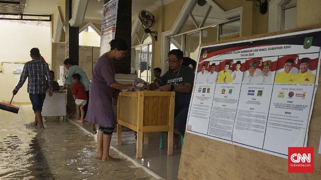 TPS 32 di wilayah Sialang Munggu, Kecamatan Tampam Pekanbaru tergenang air. Warga tetap antusias untuk menggunakan hak suara untuk memilih Gubernur Riau.
