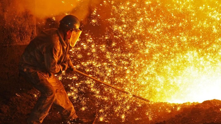 An employee works next to molten iron at a steel mill of Dongbei Special Steel in Dalian, Liaoning province, China July 17, 2018. REUTERS/Stringer  ATTENTION EDITORS - THIS IMAGE WAS PROVIDED BY A THIRD PARTY. CHINA OUT.