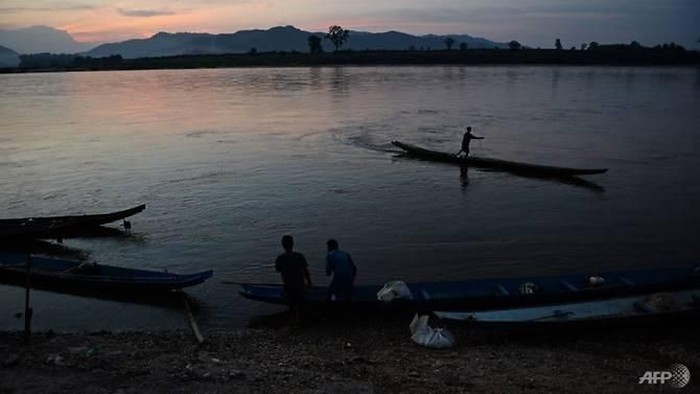 This picture taken on May 29, 2013 shows a fisherman standing on his boat as he lays his net in the Mekong river in Wiang Kaen, a district in the northern Thai province of Chiang Rai, bordering Laos. (Photo: AFP/Christophe Archambault) 
Read more at https://www.channelnewsasia.com/news/asia/hundreds-missing-in-laos-after-dam-collapse-report-10558270