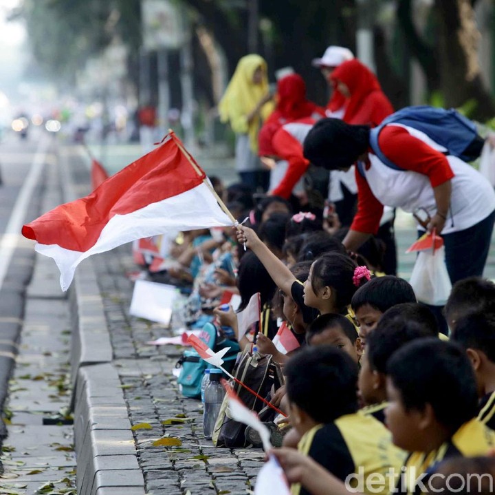 <p>Anak-anak menunggu pawai obor di Jakarta sambil duduk di trotoar. (Foto:Pradita Utama/detikcom)<br /><br /></p>