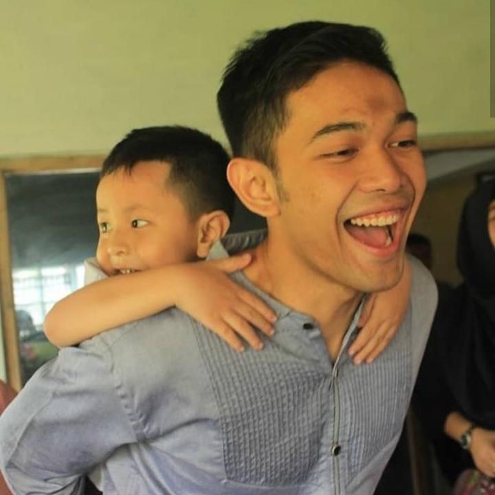 <p>Fajar sedang momong Fadly nih, Bun. Dia menggendong sang adik di punggungnya. Seru ya. (Foto: Instagram @fjralf95)<br /><br /></p>