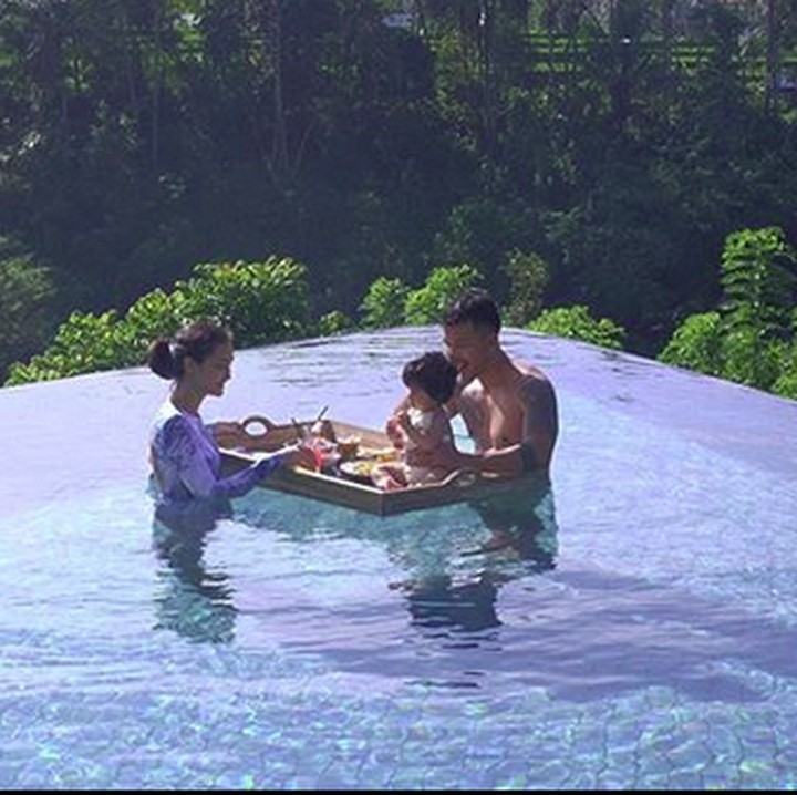 <p>Asyiknya keluarga kecil Rio dan Atiqah yang sedang sarapan di kolam renang di Bali. Pemandangannya bagus ya, Bun. (Foto: Instagram @atiqahhasiholan)</p>