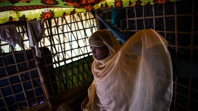 In this photograph taken on August 12, 2018, Saleema Khanam, 8, gets ready before heading to a madrassa (Islamic seminary) for her studies in Kutupalong camp, in Ukhia near Cox's Bazar.
Islamic seminaries or madrassas, catering to Rohingya children driven from Buddhist-majority Myanmar by a wave of genocidal violence, are springing up in the world's largest refugee camp in Bangladesh since a massive influx of Rohingya Muslims last year. Formal schooling, which suggests a permanent presence, is not allowed in the camps. For many children, the madrassas are the only places to learn. / AFP PHOTO / CHANDAN KHANNA