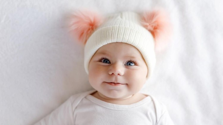 ilustrasi bayi Cute little baby boy, relaxing in bed after bath, smiling happily, daytime