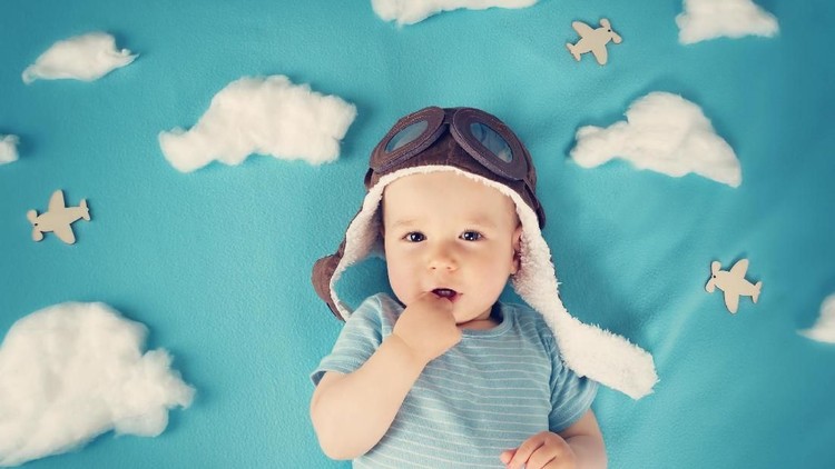Conceptual shot of a baby girl as an astronaut against a space background