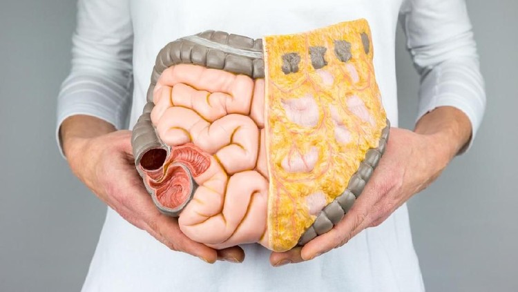 woman with colorectal cancer concept on the pink backgorund