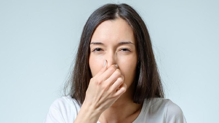 Young Woman Noticed Smell Coming From Dishwasher In Kitchen
