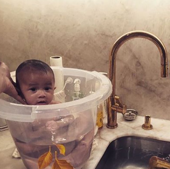 <p>Mandi bersama Kakak Luna. Karena masih kecil, Miles ditaruh di ember deh. He-he-he. (Foto: Instagram @chrissyteigen)</p>