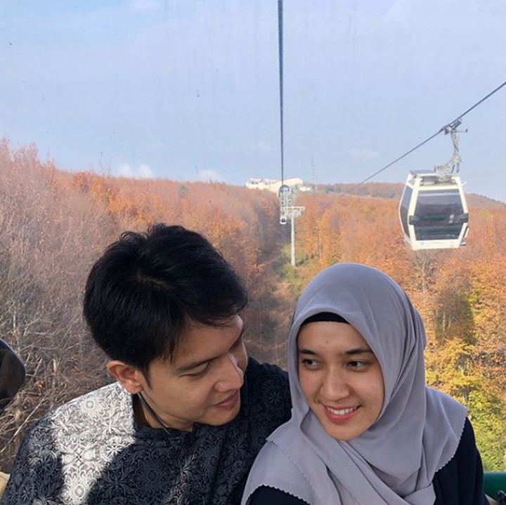 <p>Keduanya juga kerap traveling ke berbagai daerah. Kali ini, Dimas mengajak Dhini untuk naik kereta gantung berlatar pemandangan yang indah. (Foto: Instagram @ dimasseto_1)</p>