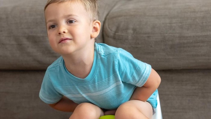 smart kids. learning how to read. toilet training. child with toilet paper, potty, and books.