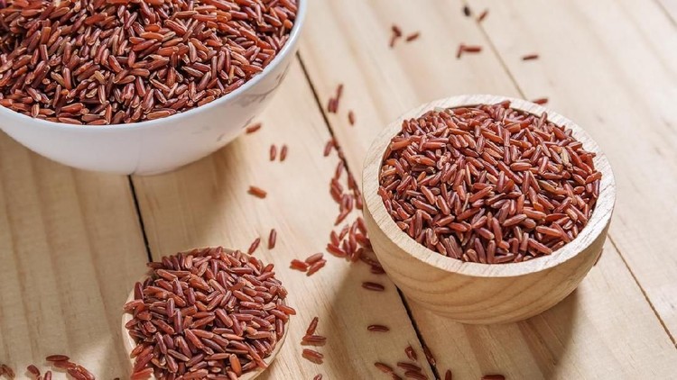 Rice berry in wooden bowl on wood background, Rice berry from asia