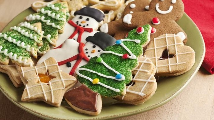 Supplies for preparing Christmas cookies decoration on a white table. Used gingerbread cookies home-handedly made it from me. They are unique pieces and can not be found anywhere.