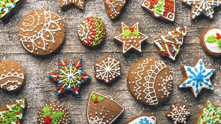 Supplies for preparing Christmas cookies decoration on a white table. Used gingerbread cookies home-handedly made it from me. They are unique pieces and can not be found anywhere.