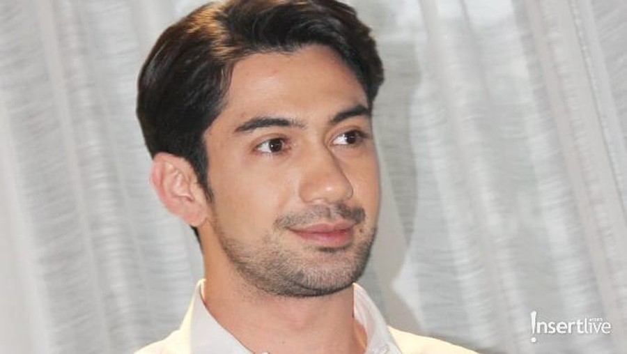 Reza Rahadian nampak bertelanjang dada pada sebuah banner.