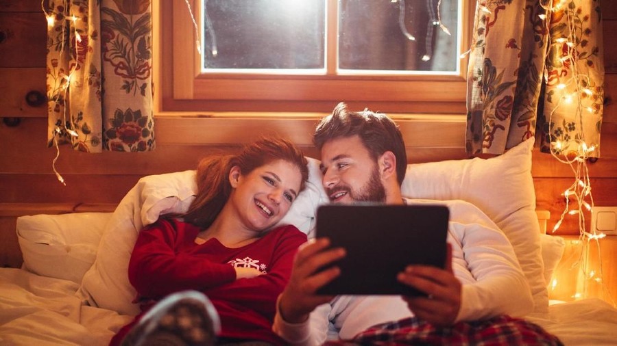 Loving couple relaxing and sleeping in bed, top view