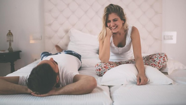 Loving couple relaxing and sleeping in bed, top view