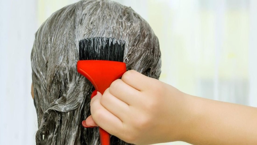 rear view of woman head dying hair.