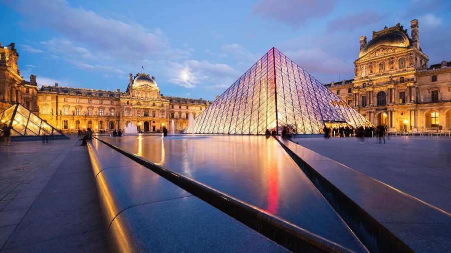 museum louvre Paris, France - May 13, 2014: View of the Louvre Museum and the Pyramid at twilight, it is one of the world's largest museums, a historic monument and a central landmark of Paris.