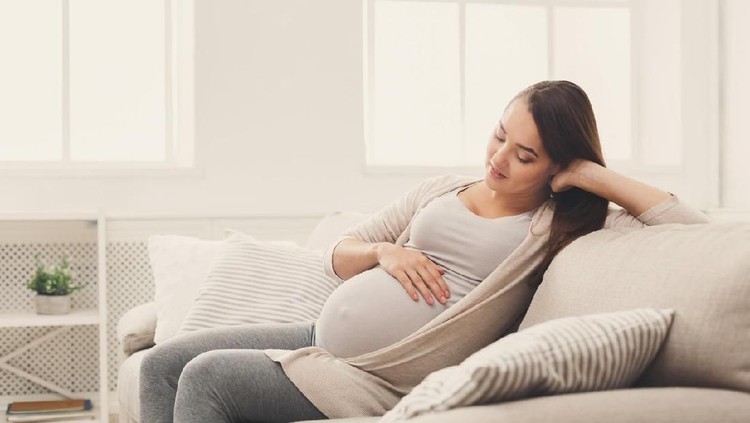 Pensive pregnant woman dreaming about child. Young happy expectant thinking about her baby and enjoying her future life, copy space. Motherhood, pregnancy, happiness concept
