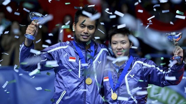 Indonesia's Tontowi Ahmad (L) and Liliyana Natsir pose with their trophies after winning their All England Open Badminton Championships mixed doubles final match against China's Zhang Nan and Zhao Yunlei in Birmingham, central England, on March 10, 2013. AFP PHOTO/BEN STANSALL (Photo by BEN STANSALL / AFP)
