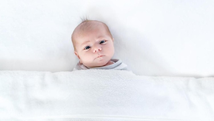 Ilustrasi bayi Sleeping 2 month old newborn baby twins wearing bunny costumes. They are swaddled together in a hugging position.