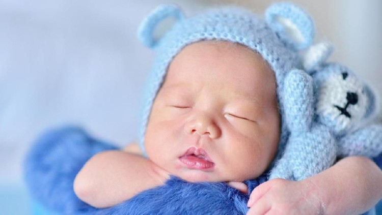 Ilustrasi bayi Close-up of a newborn sleeping at blue bed background. ( Baby born 11 days )