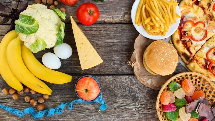 diet Fastfood and healthy food on old wooden background. Concept choosing correct nutrition or of junk eating. Top view.