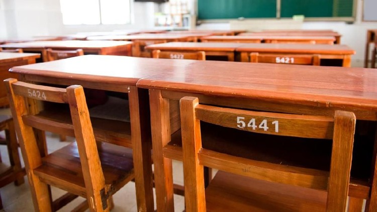 School desk chair inside an abandoned high school.