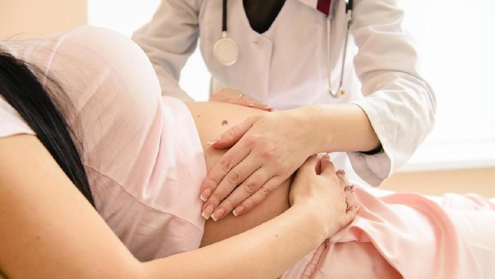 Close-up hand check of pregnancy in hospital