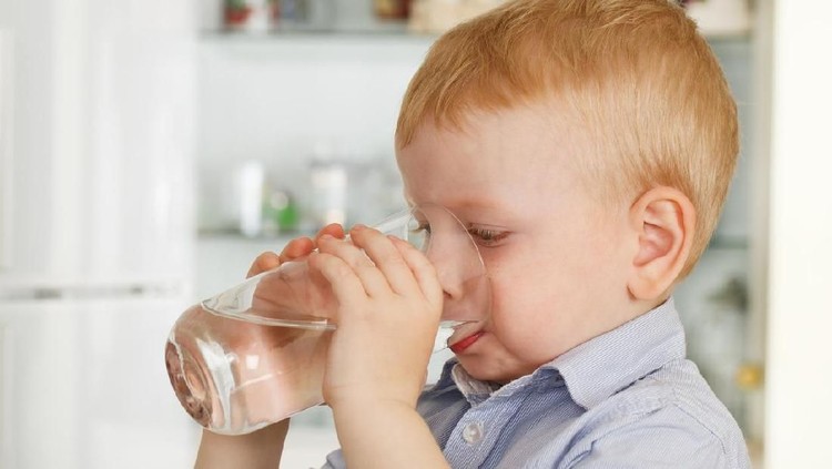Shot of a boy drinking a glass of water
