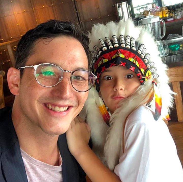 <p>Papa Mike mengajak Kenzou ke Surabaya. Wah si Kenzou pakai topi Indian yang unik banget. Jadi makin ganteng ya, Bun. (Foto: Instagram: @mike_lewis)</p>